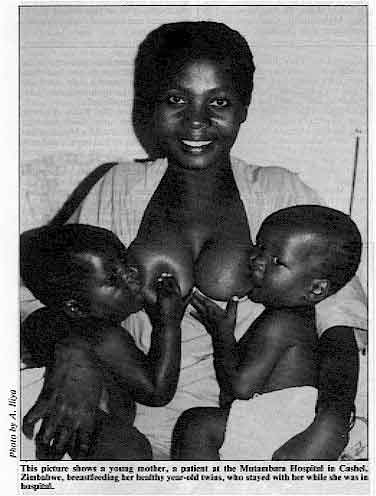 This picture shows a young mother, a patient at the Mutambara Hospital in Cashel, Zimbabwe, breastfeeding her healthy year-old twins, who stayed with her while she was in hospital. 