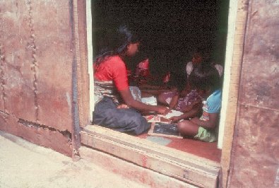 Children and sister near doorway- slide 52 - A Kind of Living