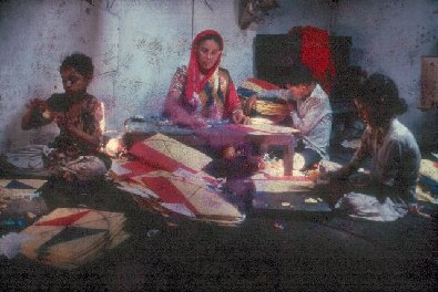 Woman and children making kites- slide 31 - A Kind of Living