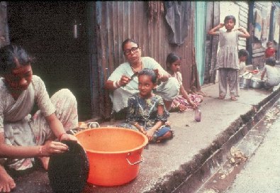 Women and children near drain- slide 42 - A Kind of Living